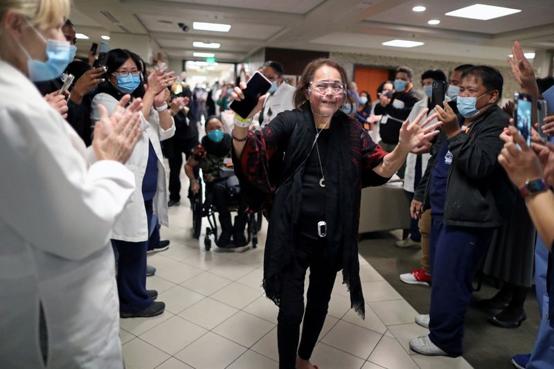 Intensive Care Unit Nurse Merlin Pambuan, is cheered by hospital