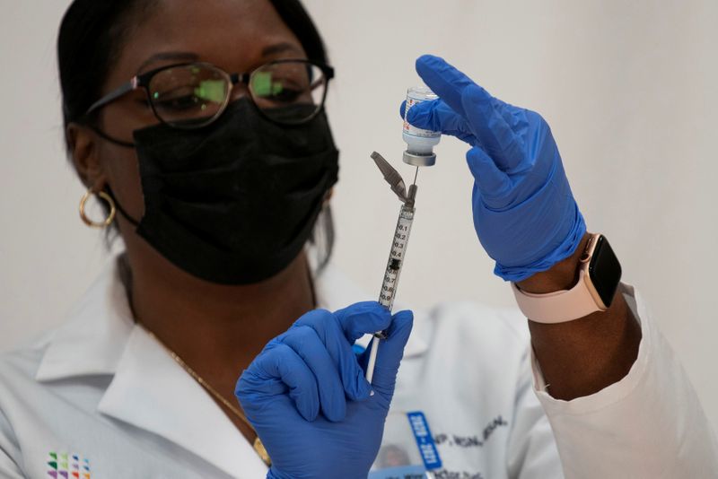 FILE PHOTO: Healthcare workers receive the Moderna COVID-19 vaccine