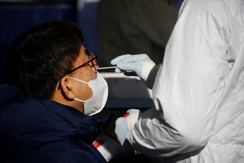 FILE PHOTO:  A man undergoes coronavirus disease (COVID-19) test