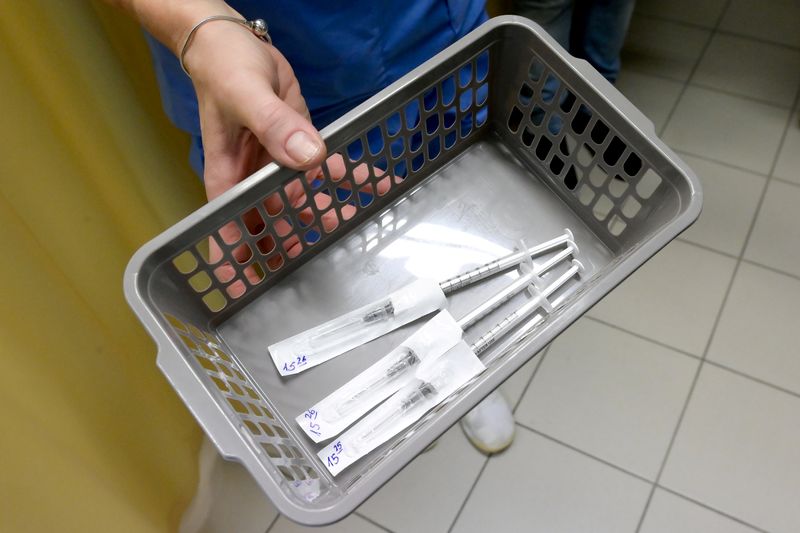 FILE PHOTO: Healthcare worker carries a tray of prepared doses
