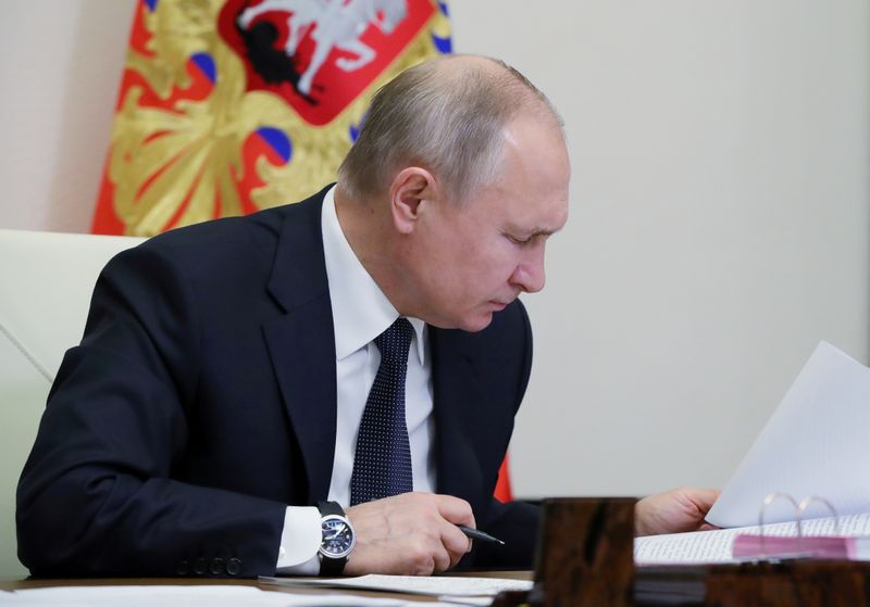 Russia’s President Vladimir Putin chairs a meeting outside Moscow