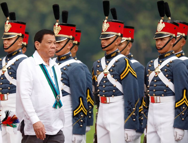 FILE PHOTO: Philippines President Rodrigo Duterte reviews military cadets during
