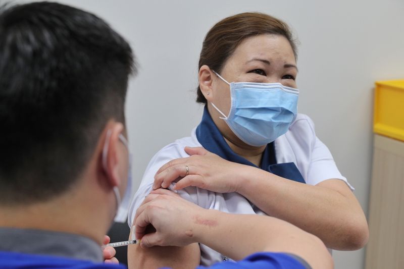 Healthcare worker Sarah Lim receives her coronavirus disease (COVID-19) vaccine