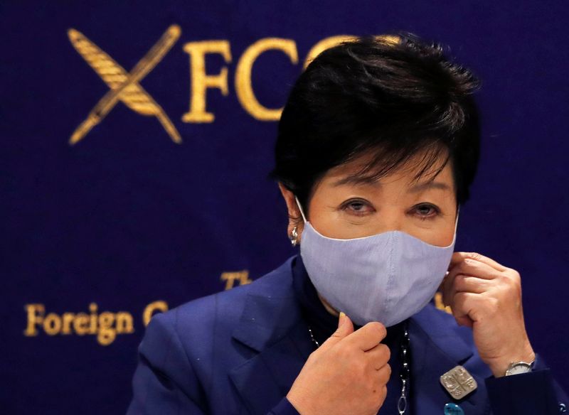 Tokyo Governor Yuriko Koike wearing a protective face mask attends