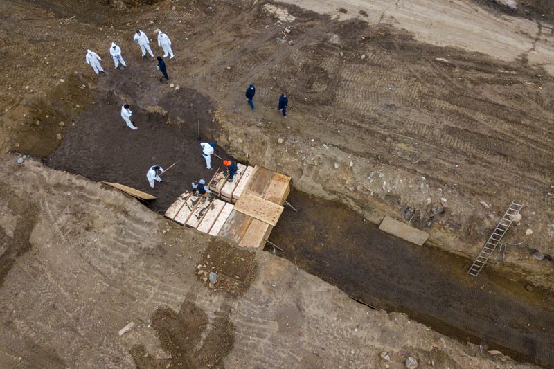 Drone pictures show bodies being buried on New York’s Hart