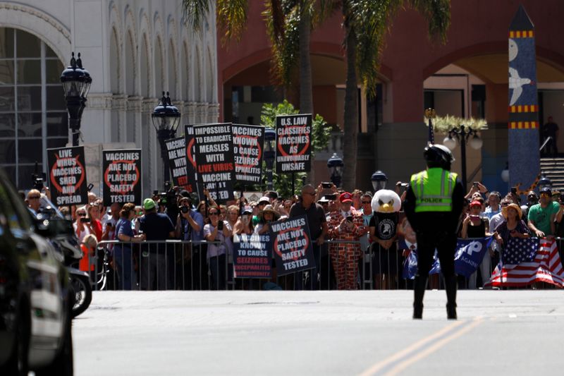 FILE PHOTO: Demonstrators, including anti-vaccine protestors, stand outside of the