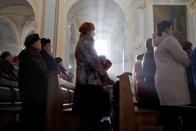 People attend a service in a church as they celebrate