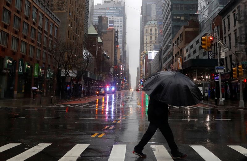 Man walks in heavy rain and high winds across West