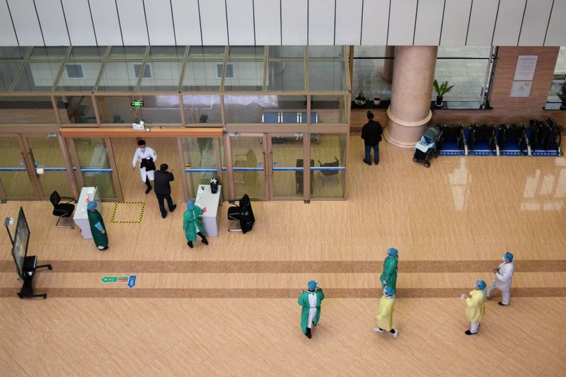 Medical workers are seen near the entrance at a hospital