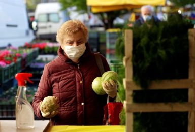 A customer buys vegetables in Prague