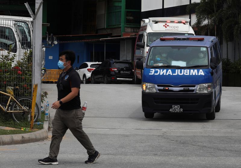 Ambulances leave the Punggol S11 migrant workers’ dormitory during the