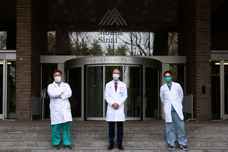 Doctors pose outside The Mount Sinai Hospital in Manhattan, New