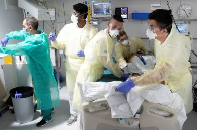 FILE PHOTO: Staff treat a patient in the intensive care