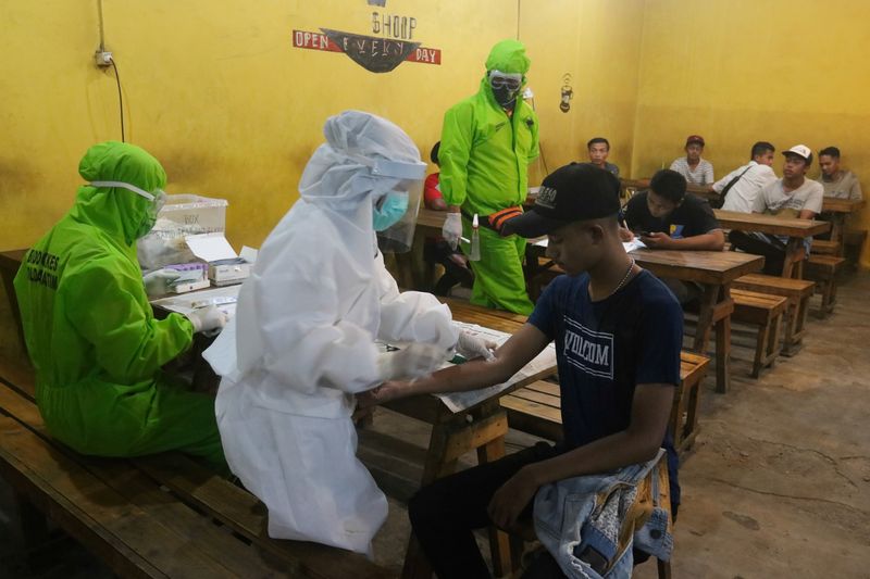 FILE PHOTO:  Medical officers wearing protective gear take a