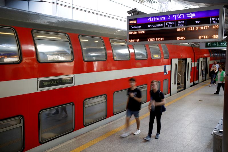 People walk on the platform at Israel’s new high-speed rail