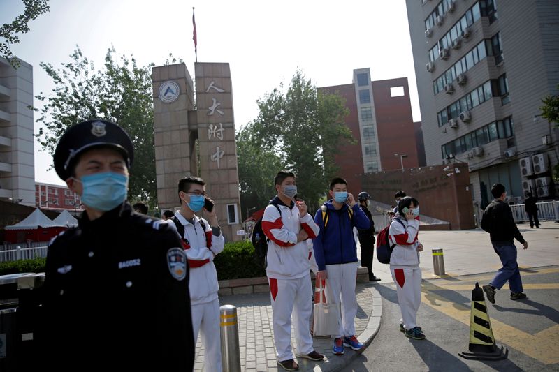FILE PHOTO: Students wearing face masks leave a school in
