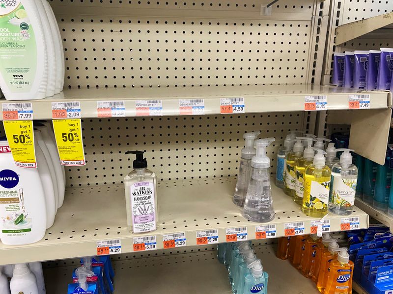 Shelves of a CVS pharmacy are stripped of hand sanitizer
