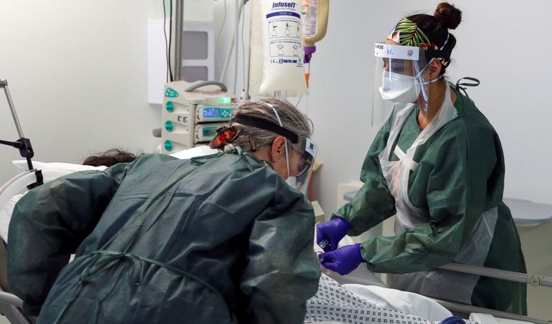 FILE PHOTO: Nurses care for a patient in an Intensive