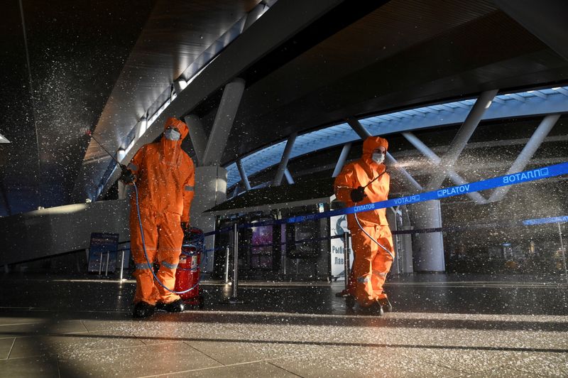 FILE PHOTO: Specialists sanitize an airport near Rostov-on-Don