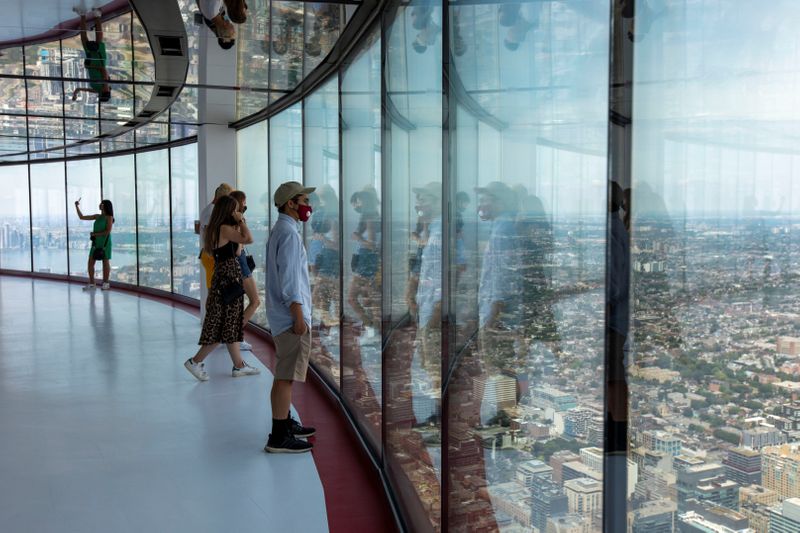 Visitors view panoramic city scenes from the CN Tower in