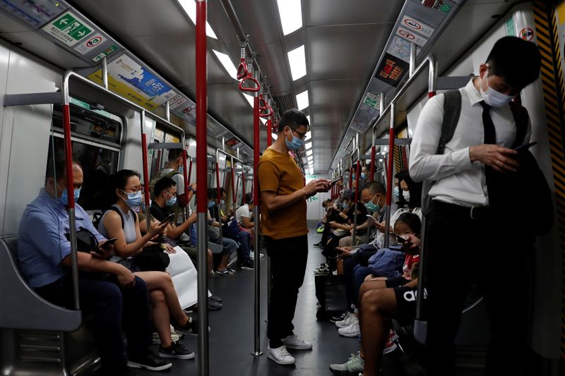 FILE PHOTO: Passengers wear surgical masks in an MTR train,