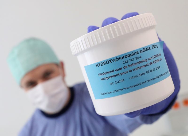 FILE PHOTO: A pharmacist displays a box of Hydroxychloroquine at