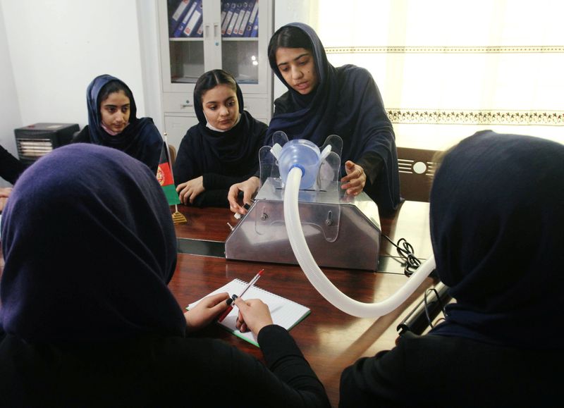 Members of an Afghan all-female robotics team work on an
