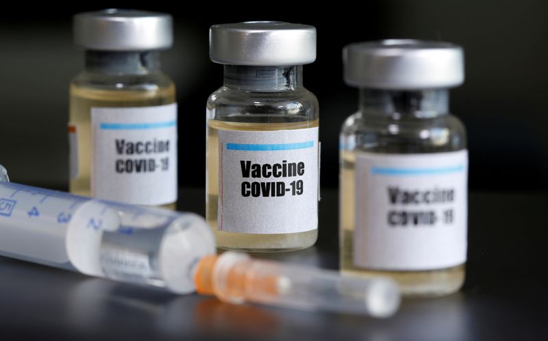 Small bottles labeled with a “Vaccine COVID-19” sticker and a