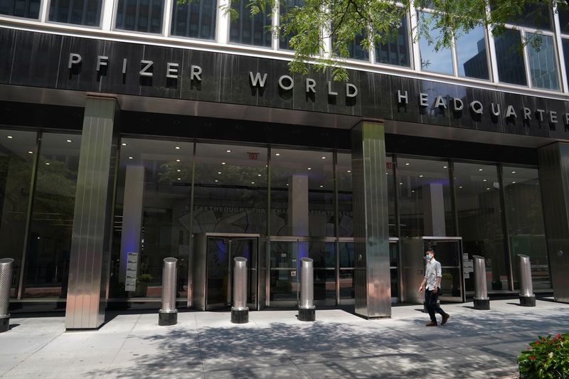 FILE PHOTO: A man walks past the Pfizer Headquarters in