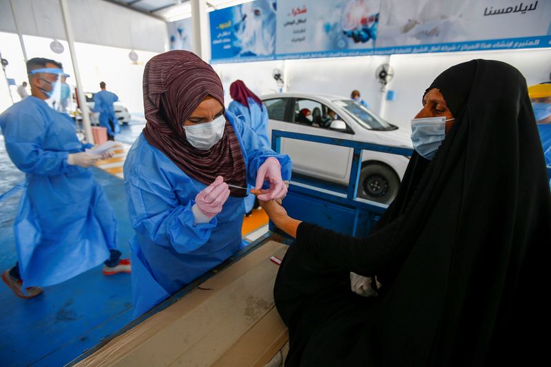 A healthcare worker collects blood samples from passengers at a