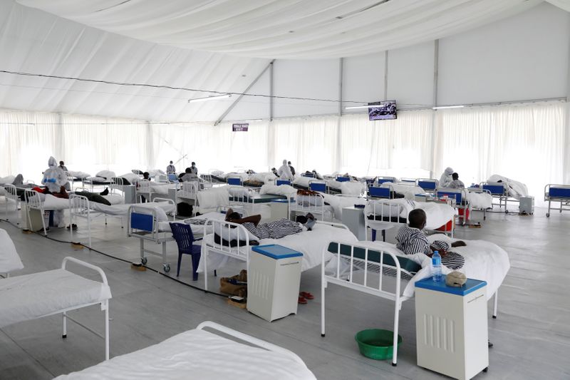 COVID-19 patients rest on their beds inside a field hospital
