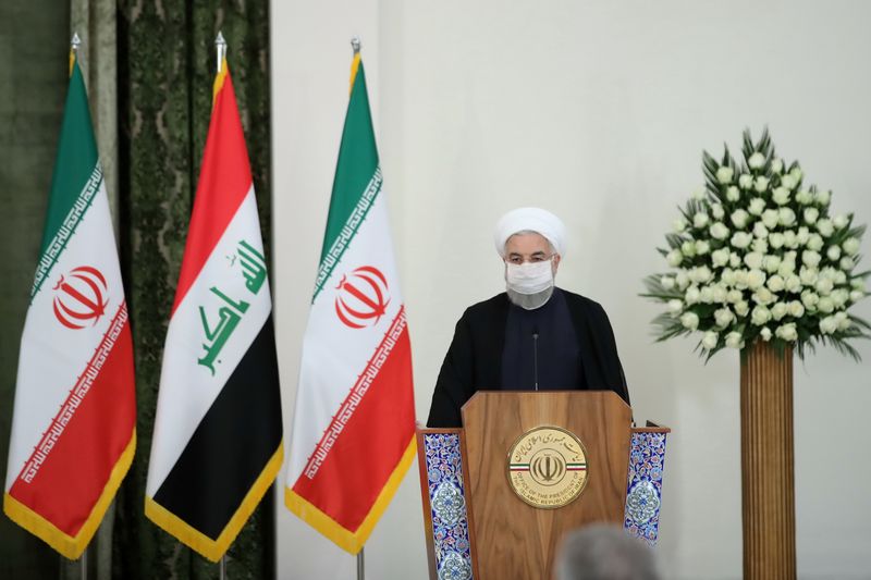 Iranian President Hassan Rouhani attends a news conference with Iraqi