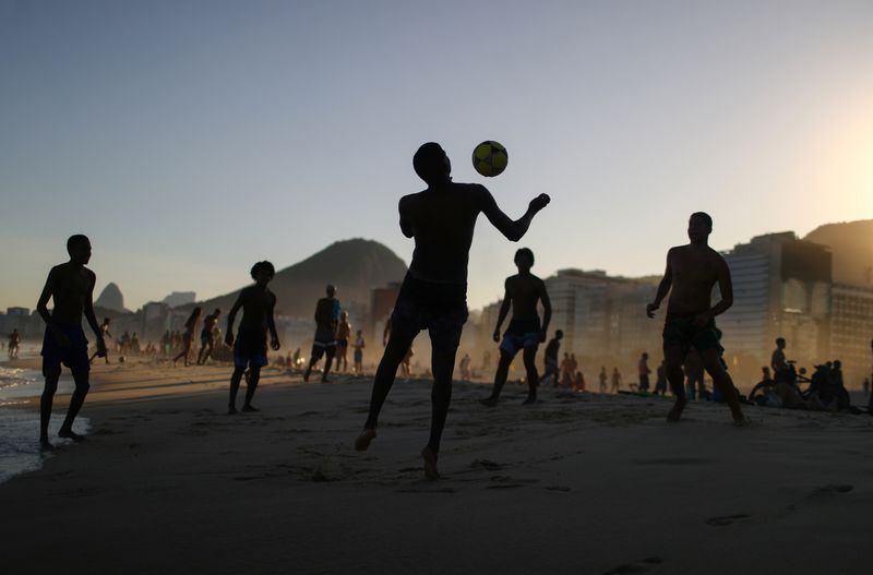 Teenagers play with a ball, amid the coronavirus disease (COVID-19)