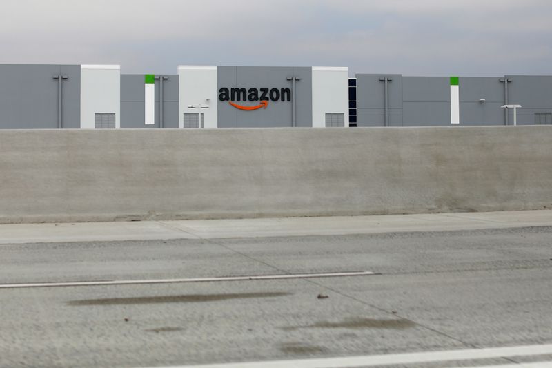 An Amazon distribution center is shown next to the freeway