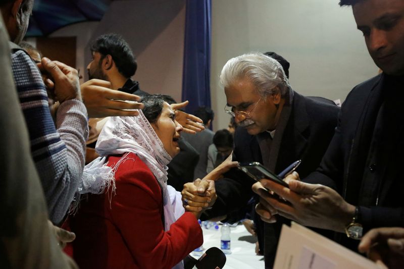 FILE PHOTO: Pakistan’s health minister, Zafar Mirza, interacts with a