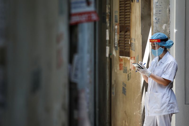 A healthcare worker is seen at a lane near the