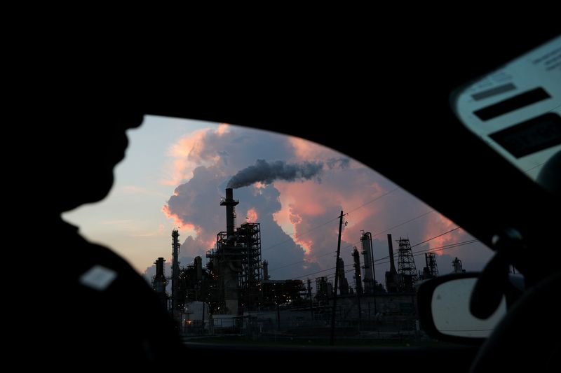 FILE PHOTO: A police officer drives past a refinery in
