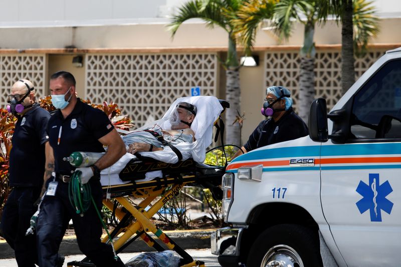 FILE PHOTO: Emergency Medical Technicians (EMT) leave with a patient