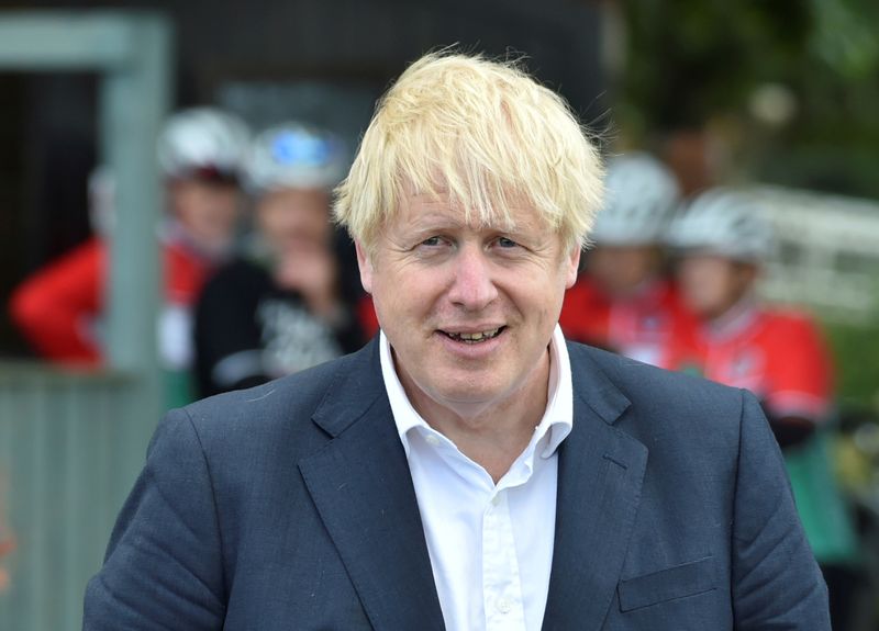Britain’s Prime Minister Boris Johnson speaks to local people at