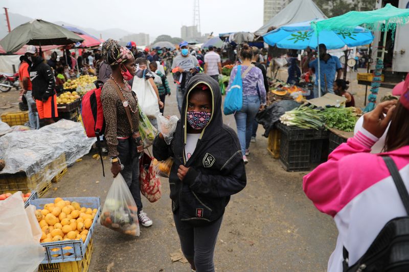 FILE PHOTO: A teenager walks at the Coche wholesale market