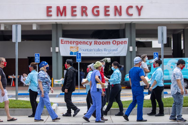 Healthcare workers protest outside their hospital during the outbreak of