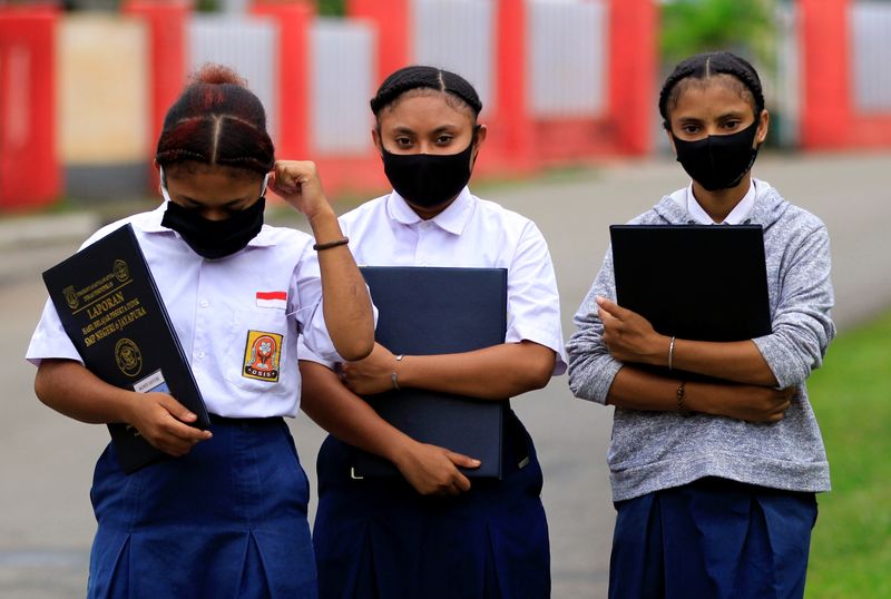 Students wear protective masks at a school amid coronavirus disease