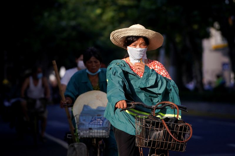 FILE PHOTO: A woman wearing a mask is seen on