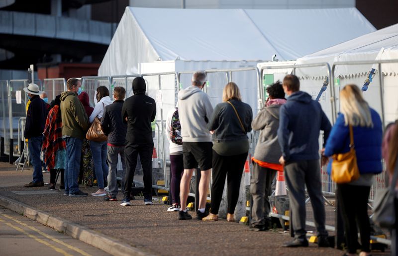FILE PHOTO: People queue outside a test centre in Southend-on-sea
