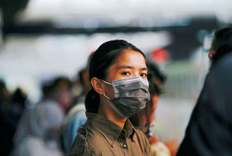 A woman wears a protective face mask at the Tanah
