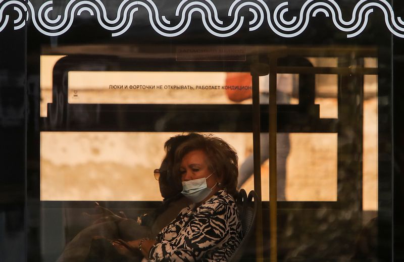 FILE PHOTO: An elderly woman in a protective face mask