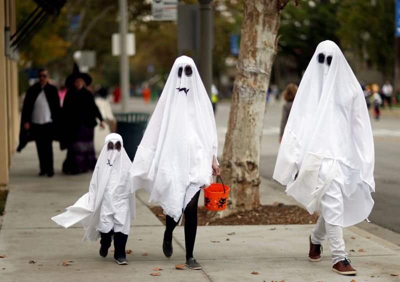 FILE PHOTO: People wearing costumes walk during Halloween in Sierra