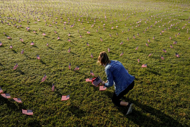 American flags representing 200,000 lives lost due to coronavirus are