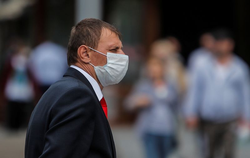 FILE PHOTO: A security guard wearing a protective face mask