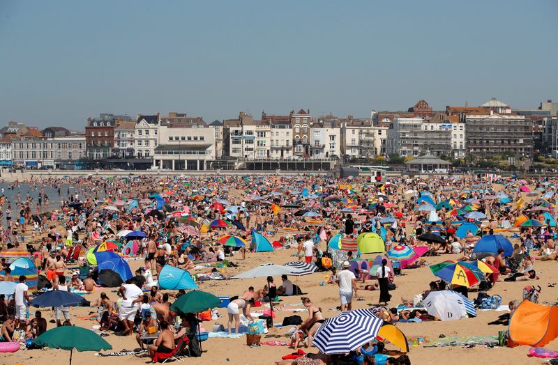 FILE PHOTO: People enjoy the hot weather on Margate beach